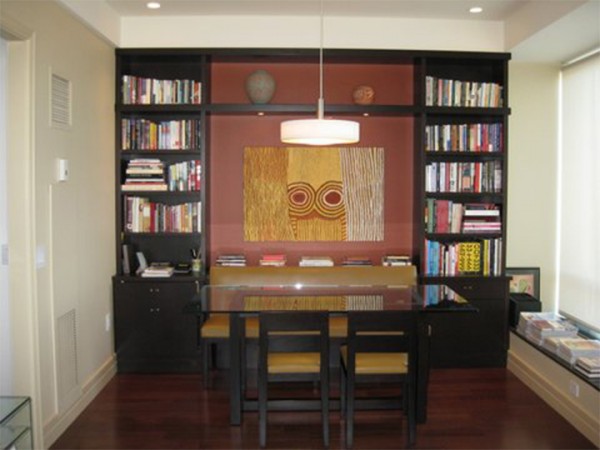 bookshelves with a table in a room